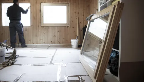 Mann som skifter ut vinduer